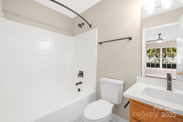 a white toilet sitting next to a bathroom sink
