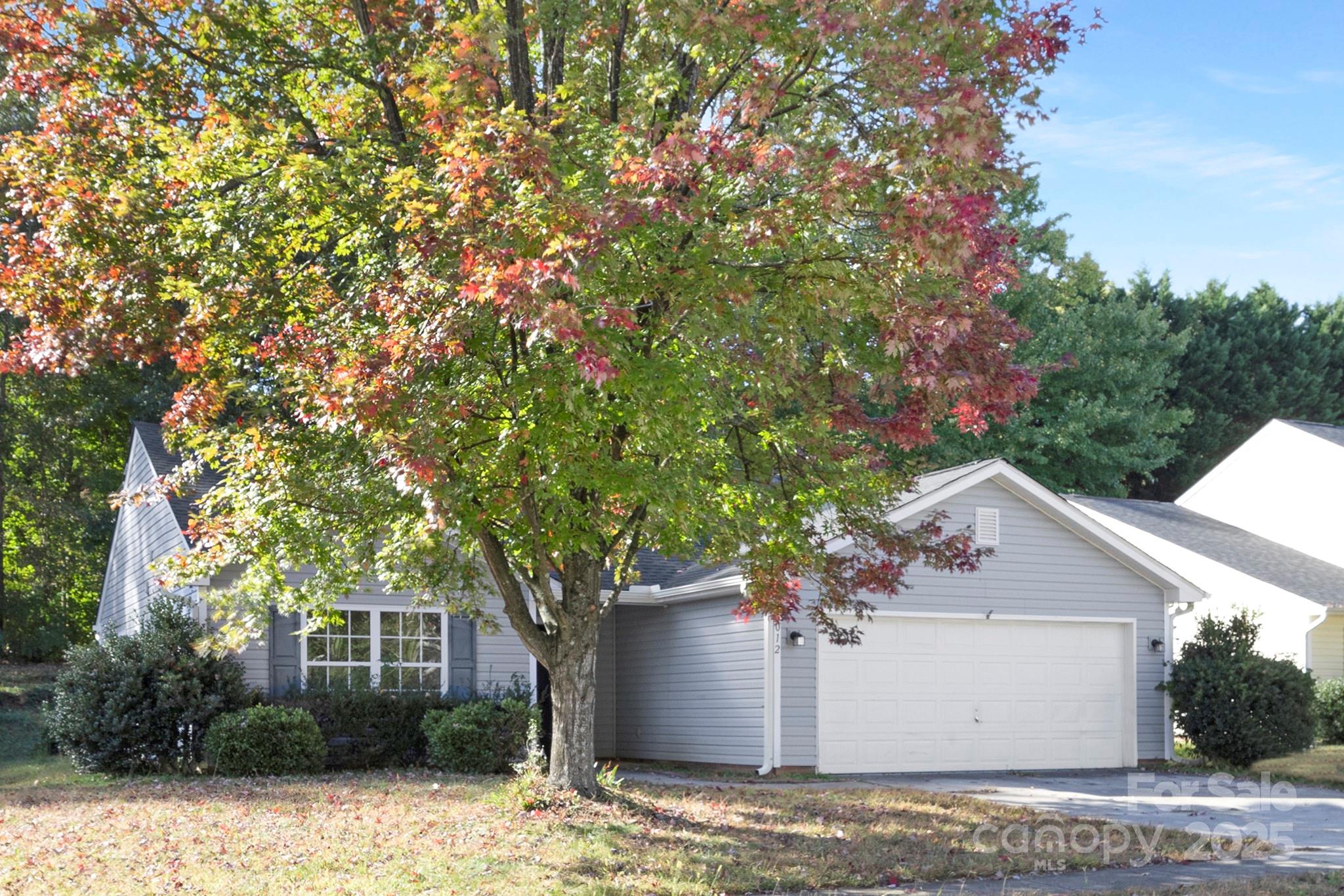 2012 Pheasant Glen Road Charlotte, NC 28214 - Photo 16 of 20 a front view of a house with a yard and garage