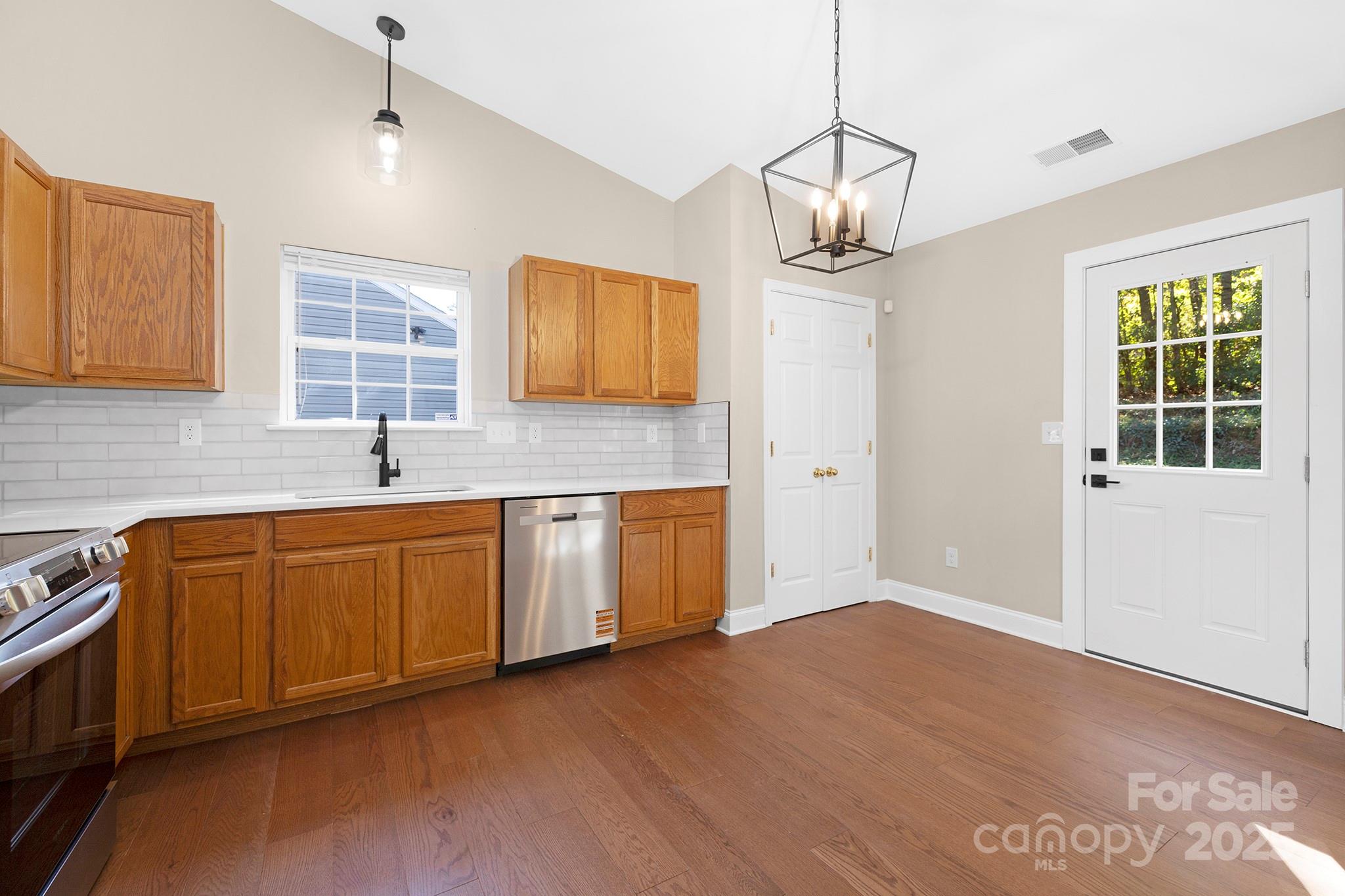 2012 Pheasant Glen Road Charlotte, NC 28214 - Photo 4 of 20 a kitchen with sink refrigerator and window