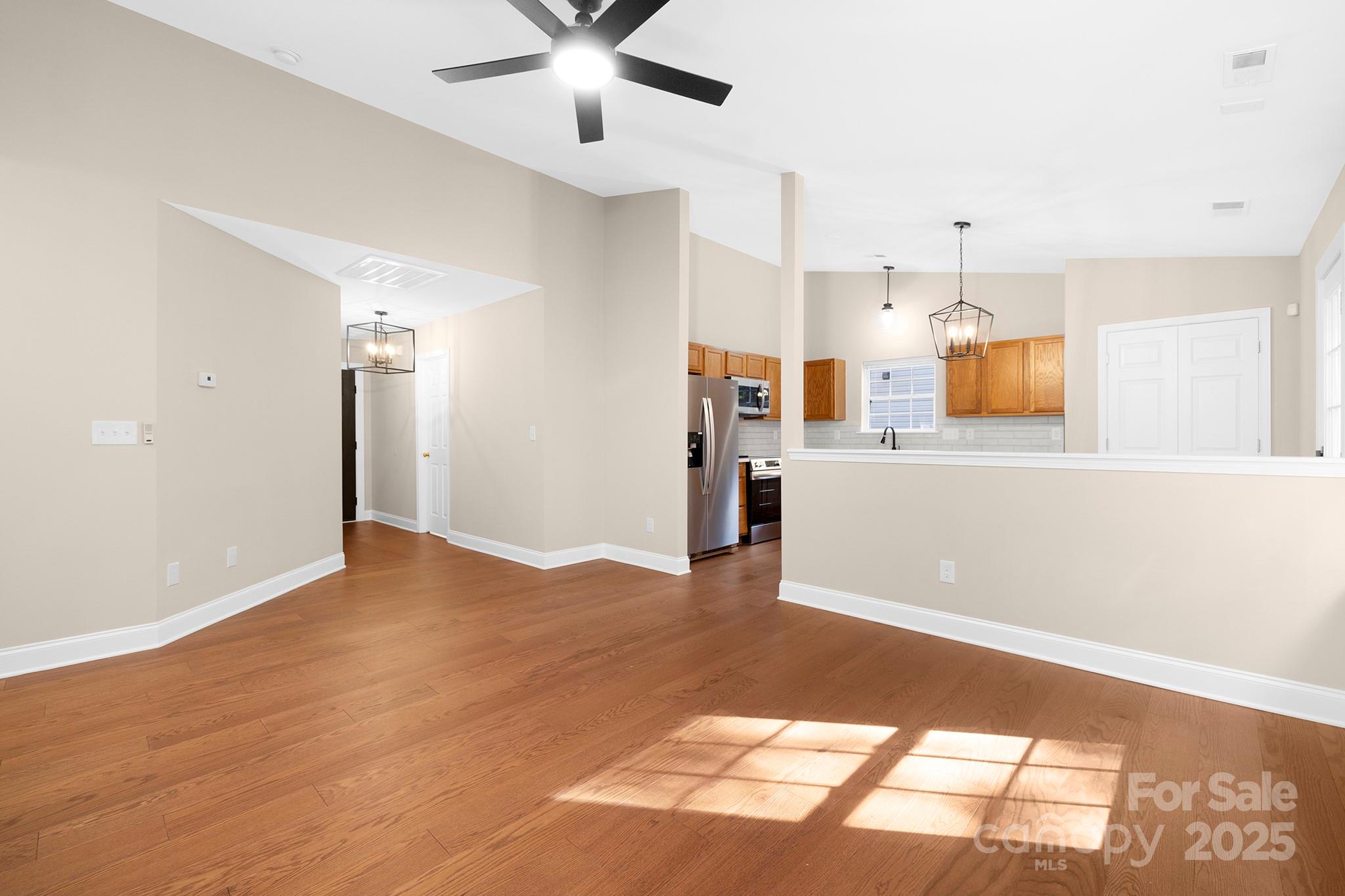 2012 Pheasant Glen Road Charlotte, NC 28214 - Photo 5 of 20 a view of a kitchen with a refrigerator cabinets and a wooden floor