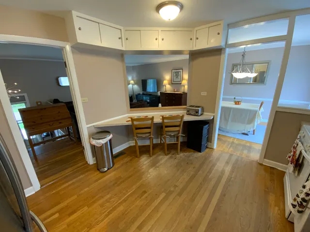 a view of a workspace with furniture and wooden floor