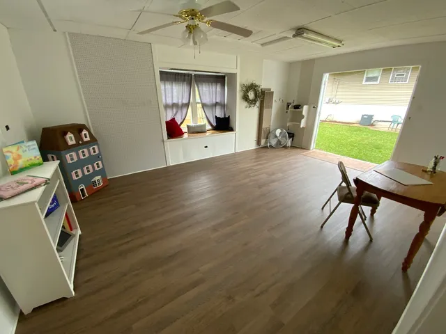 a view of a livingroom with furniture and a window