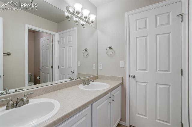 8740 Del Rio Road Peyton, CO 80831 - Photo 16 of 27 Jack-and-Jill bathroom double vanity