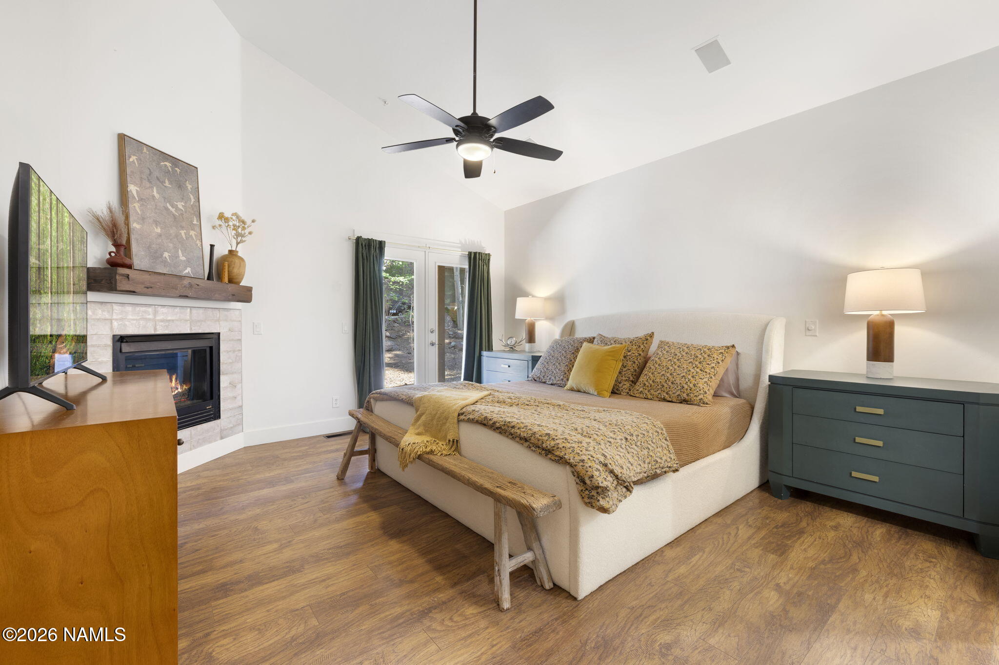 3495 West Lead Rope Flagstaff, AZ 86005 - Photo 22 of 49 a spacious bedroom with a bed and a fireplace