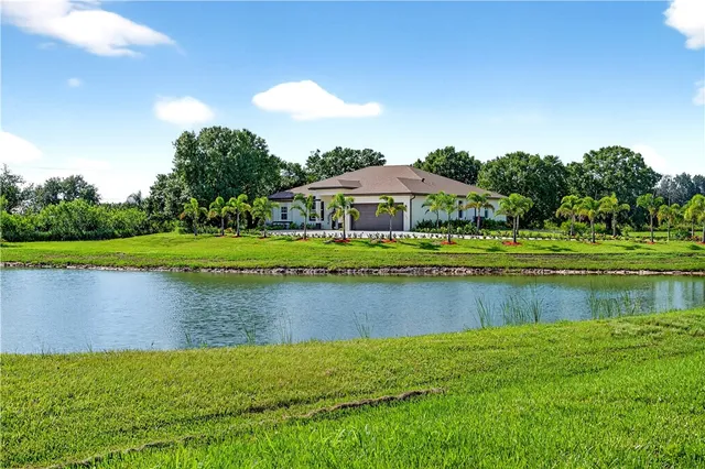 a view of a lake with a house in the background