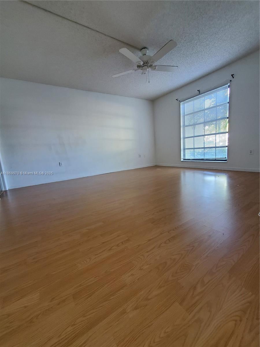 5550 Northwest 44th Street, Unit 111B Lauderhill, FL 33319 - Photo 11 of 22 wooden floor in an empty room with a window