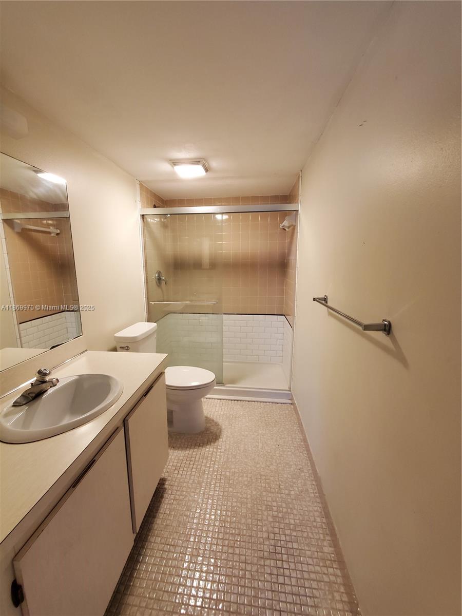 5550 Northwest 44th Street, Unit 111B Lauderhill, FL 33319 - Photo 14 of 22 a bathroom with a sink a toilet and shower
