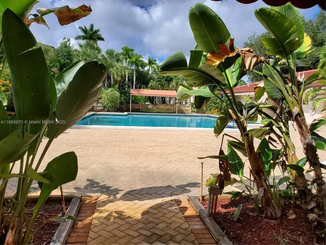 a view of a chairs and table in the backyard