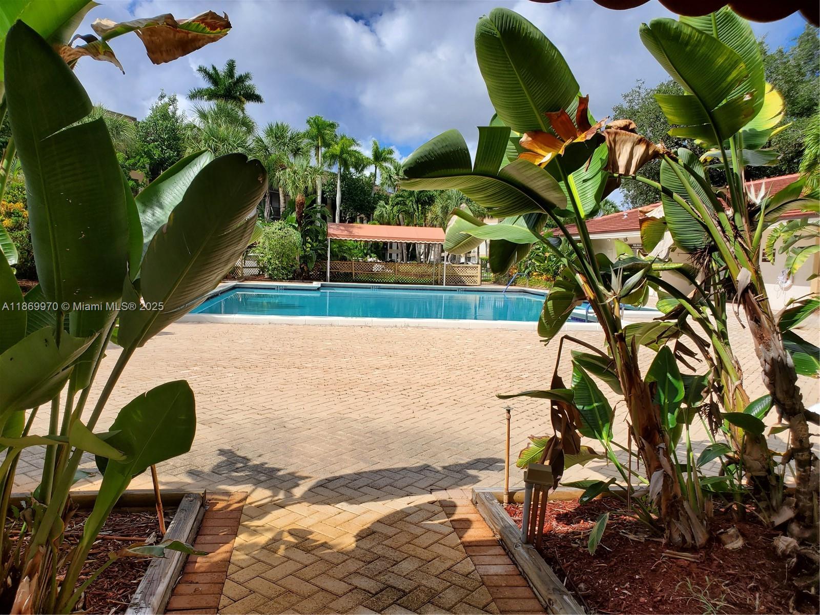 5550 Northwest 44th Street, Unit 111B Lauderhill, FL 33319 - Photo 19 of 22 a view of a chairs and table in the backyard