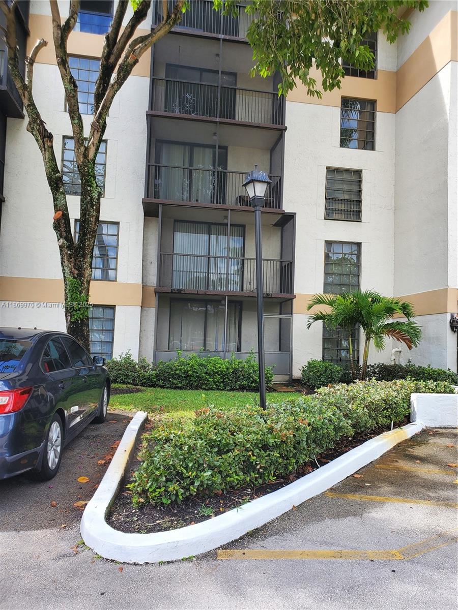 5550 Northwest 44th Street, Unit 111B Lauderhill, FL 33319 - Photo 2 of 22 a view of multiple houses with a yard