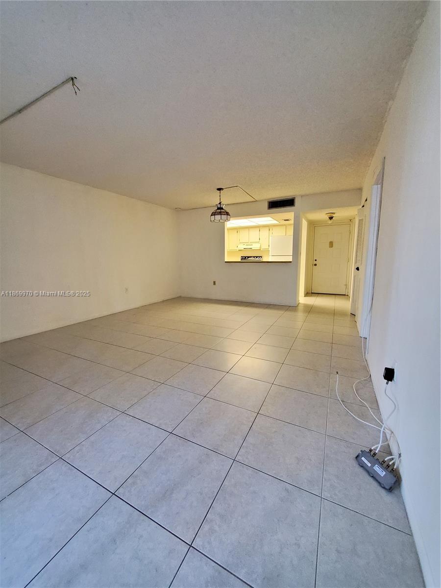 5550 Northwest 44th Street, Unit 111B Lauderhill, FL 33319 - Photo 6 of 22 a view of an empty room with a window