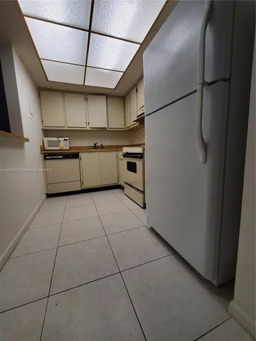 a kitchen with stainless steel appliances granite countertop a sink a stove a refrigerator and cabinets