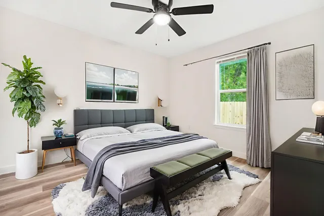 a bedroom with a bed and a window