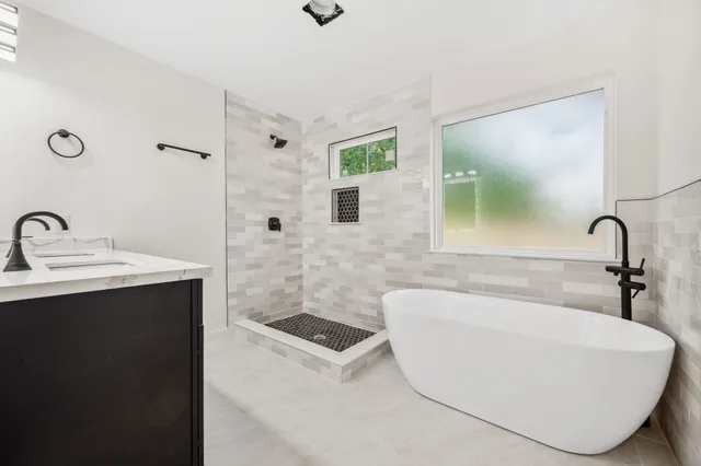 a bathroom with a bathtub and a sink