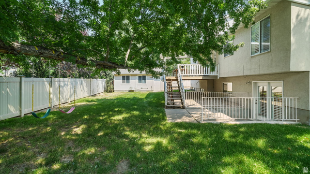 11128 South Barrett Pk Circle Sandy, UT 84092 - Photo 30 of 36 Expansive backyard featuring a green lawn, mature trees providing natural shade, and a white privacy fence