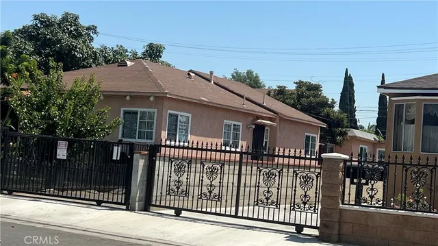 a front view of a house with a iron gate