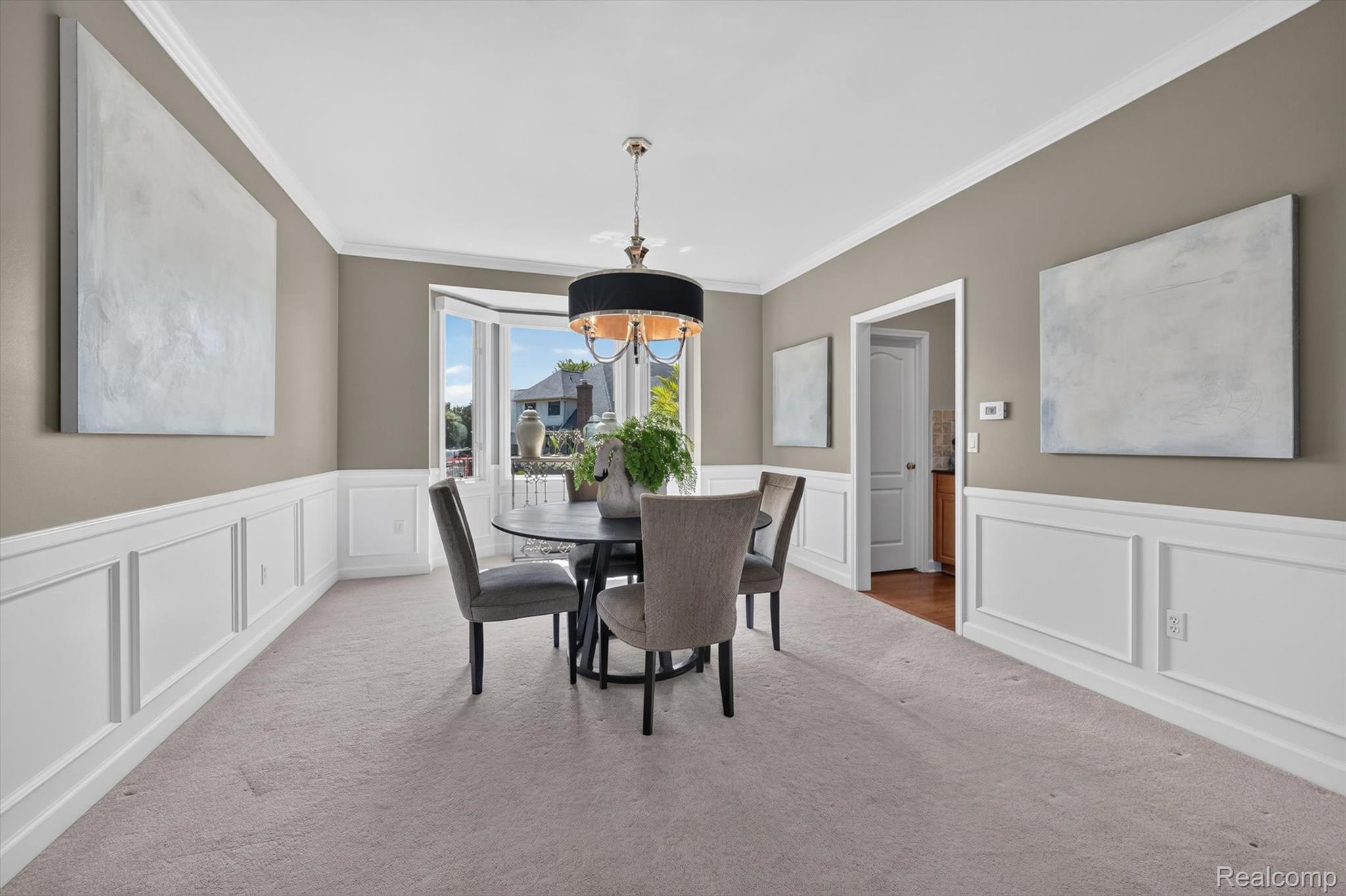 3804 Elk Drive Rochester, MI 48306 - Photo 24 of 75 Formal dining area featuring extensive wainscoting and crown molding