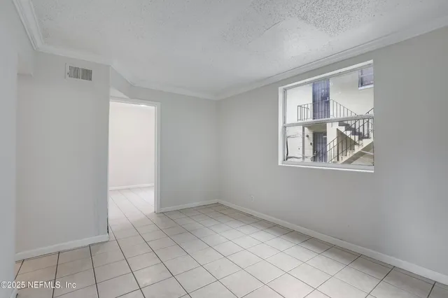 a view of an empty room with windows