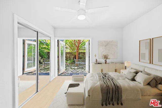 a bedroom with a bed and a large window