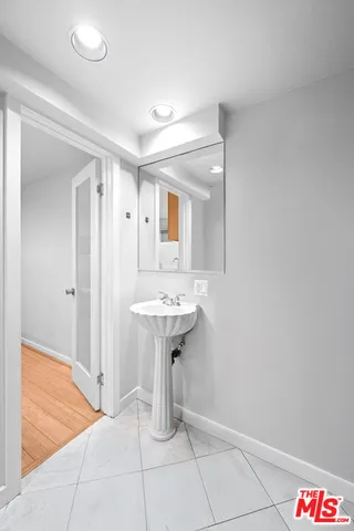 a bathroom with a sink a mirror and a shower