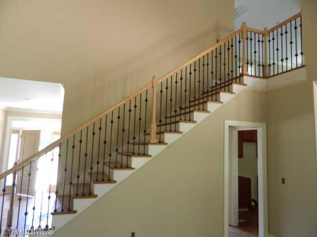 8928 Grove Park Drive Oak Ridge, NC 27310 - Photo 3 of 5 Entry. Nice stairway treatment. Vaulted Great Room
