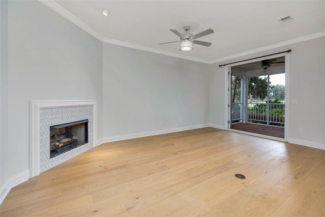 119 Kiln Trail St. Simons Island, GA 31522 - Photo 10 of 23 Living area, fireplace and Open 8 ft. doors to Porch