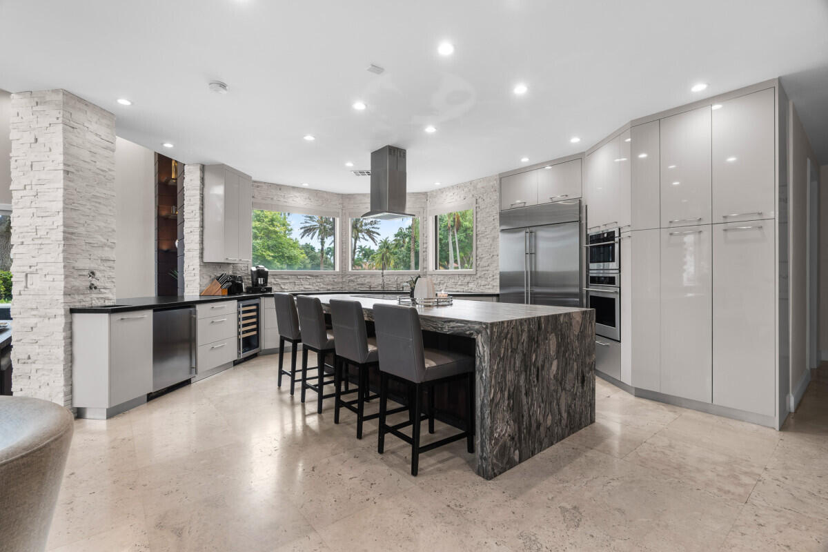 3500 Windmill Ranch Road Weston, FL 33331 - Photo 16 of 47 a kitchen with stainless steel appliances a dining table chairs and refrigerator
