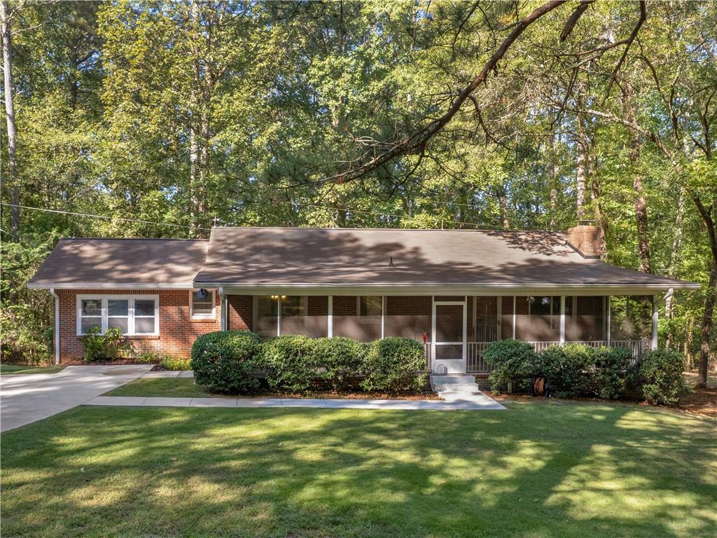 2719 Samsum Road Southwest Stockbridge, GA 30281 - Photo 1 of 1 a front view of a house with a garden