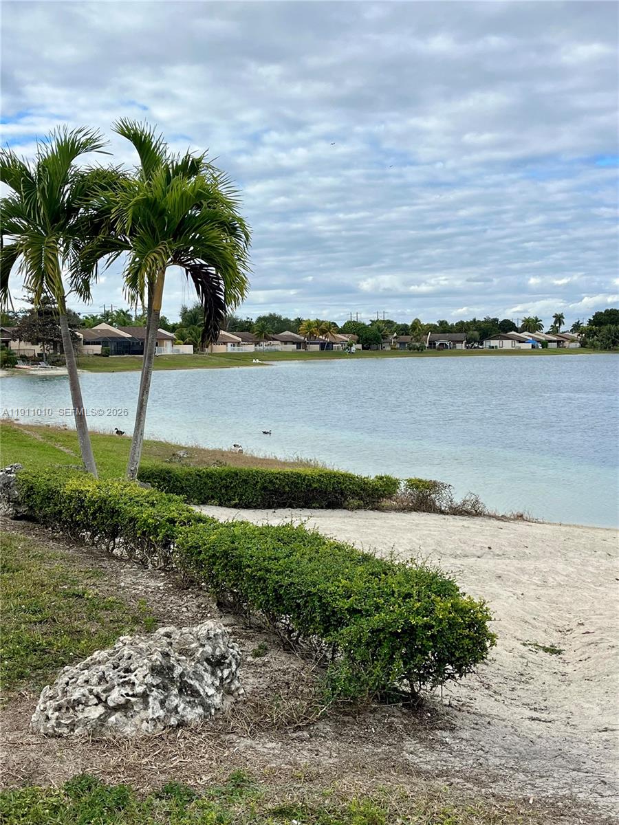 12215 Southwest 119th Terrace Miami, FL 33186 - Photo 14 of 17 a view of a lake with a lawn chairs