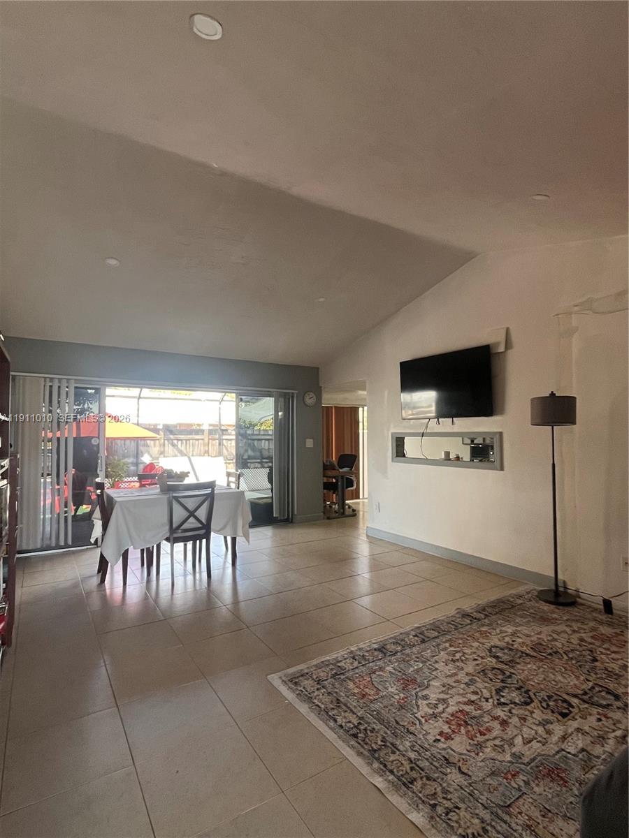 12215 Southwest 119th Terrace Miami, FL 33186 - Photo 3 of 17 a living room with furniture and a flat screen tv