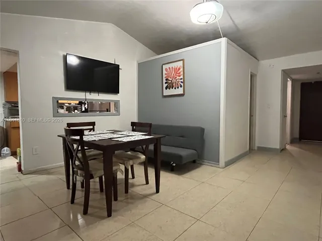 a view of a livingroom with furniture and a flat screen tv