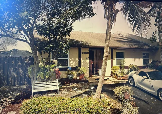 a view of a house with backyard outdoor seating and barbeque oven
