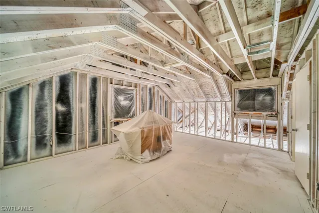 a view of a porch with wooden floor and outdoor seating