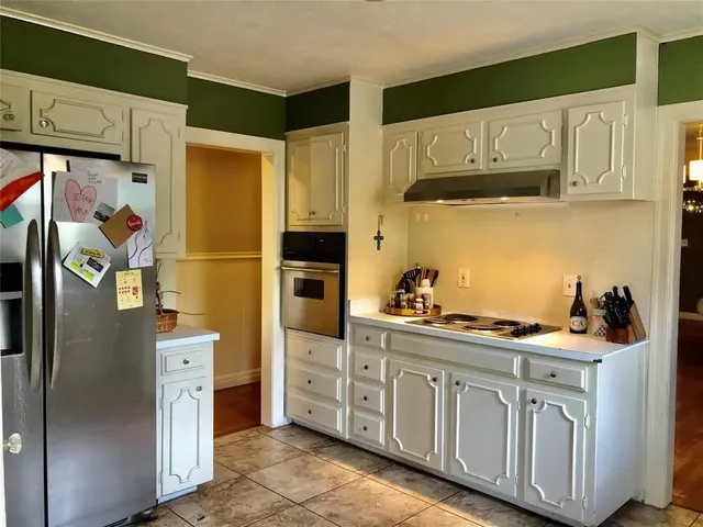 a kitchen with cabinets appliances and a window