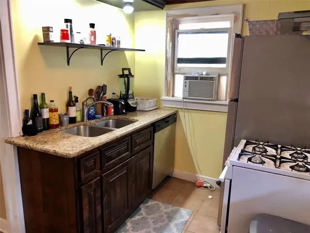 a kitchen with a refrigerator and a stove