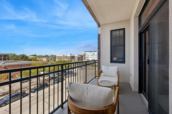 a view of a balcony with chairs