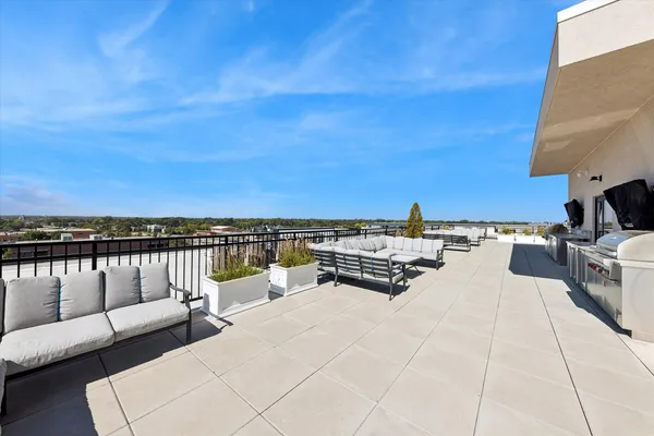 a view of a terrace with couches and sky view