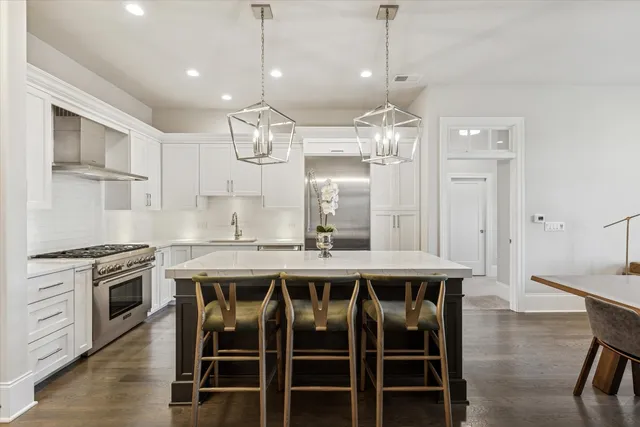 a view of a dining room with furniture a chandelier and wooden floor