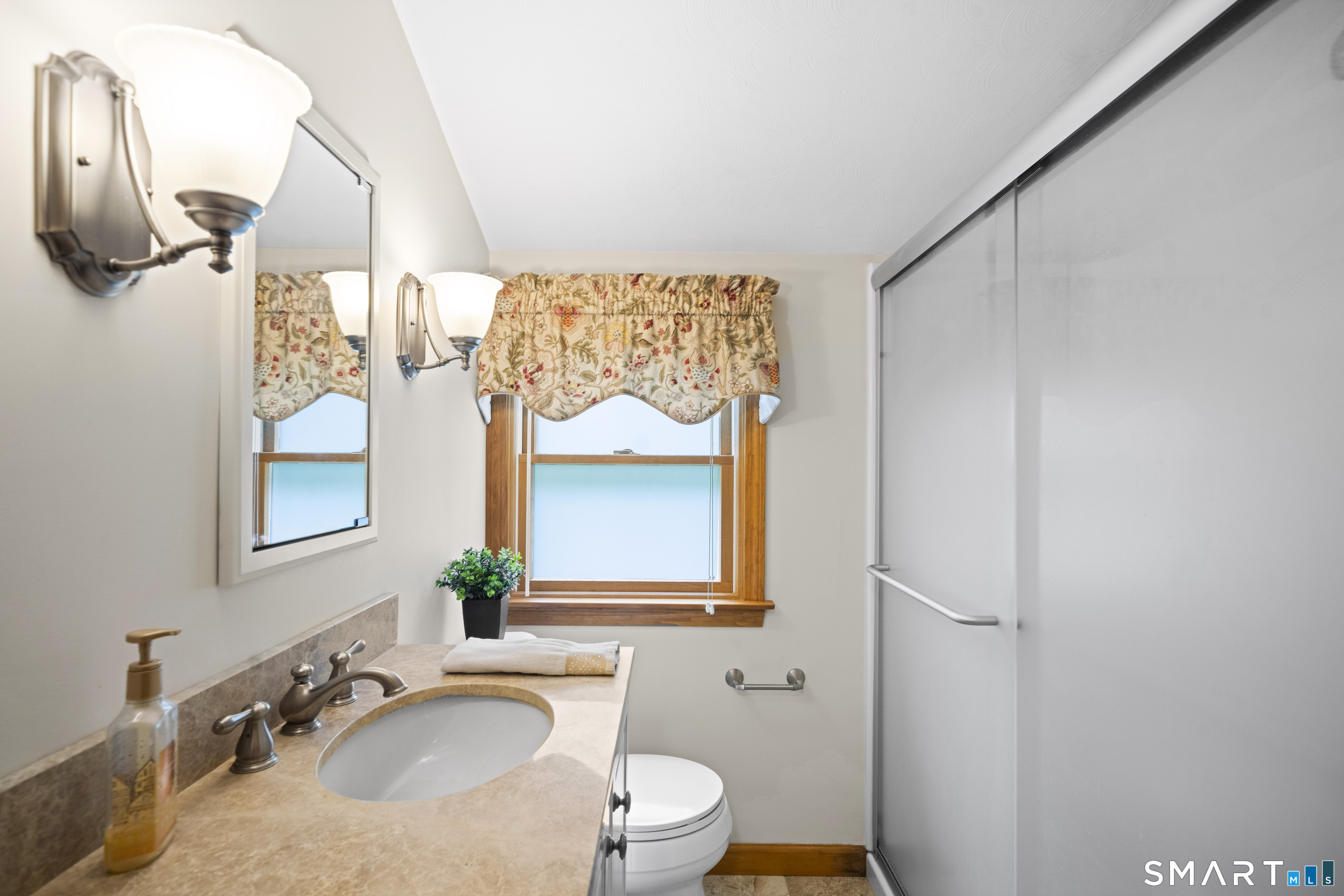 6 Cartier Road Enfield, CT 06082 - Photo 30 of 40 a bathroom with a granite countertop sink vanity mirror and toilet