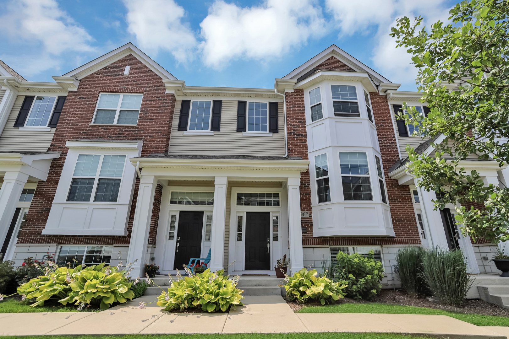 2967 Madison Drive Naperville, IL 60564 - Photo 1 of 24 front view of a brick house with a yard
