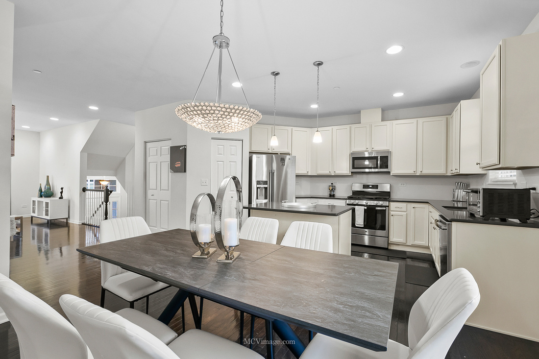 2967 Madison Drive Naperville, IL 60564 - Photo 8 of 24 a kitchen with stainless steel appliances granite countertop a kitchen island a stove a table and chairs