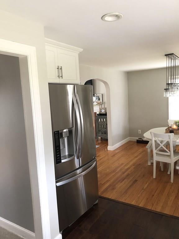 16 Mayfield Street Springfield, MA 01108 - Photo 3 of 20 a kitchen with stainless steel appliances wooden floor and chair
