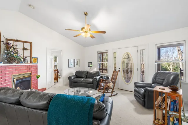 a living room with furniture and a fireplace