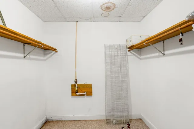 a bedroom with two beds and wooden floor