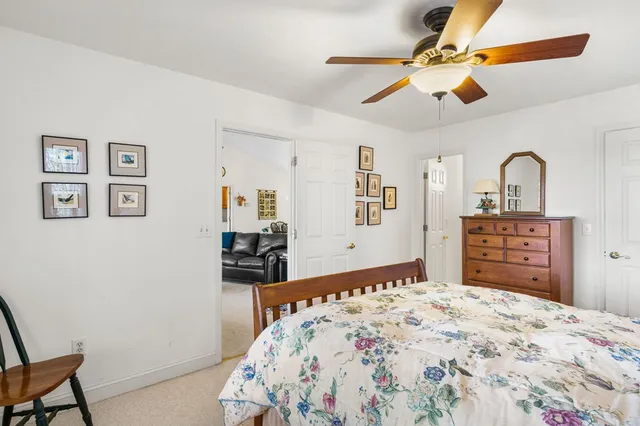 a bedroom with a bed a window and a chandelier