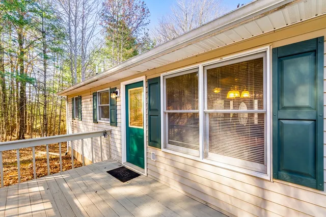 a view of a porch with wooden floor and windows