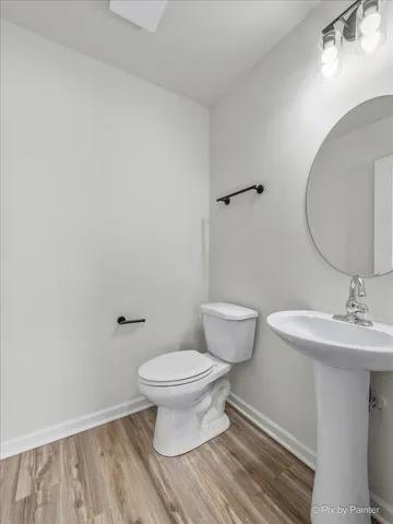 a bathroom with a sink toilet and a mirror