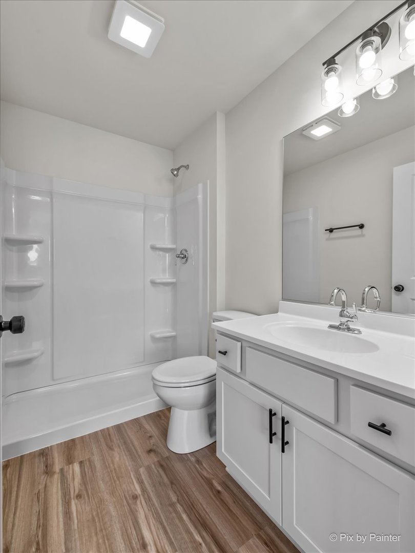 611 Apple Valley Road Harvard, IL 60033 - Photo 22 of 29 a bathroom with a sink a toilet and shower