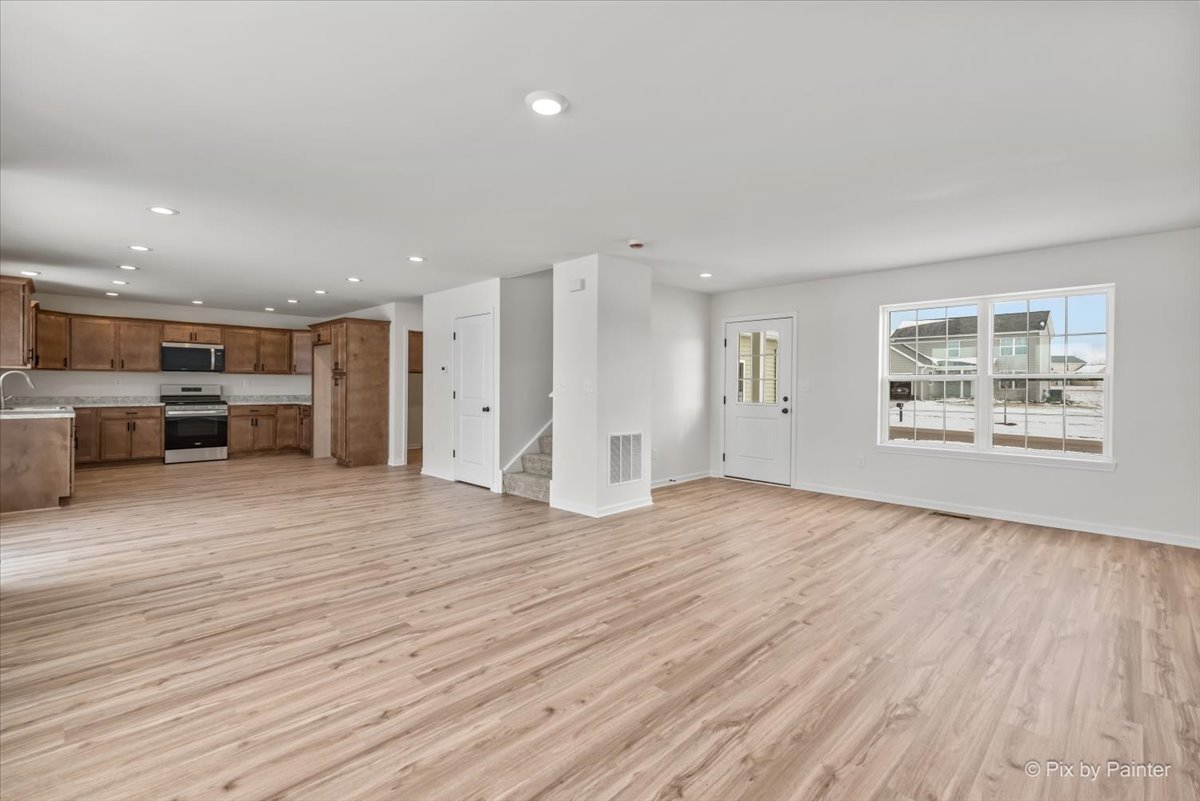 611 Apple Valley Road Harvard, IL 60033 - Photo 10 of 29 a view of kitchen with furniture and wooden floor