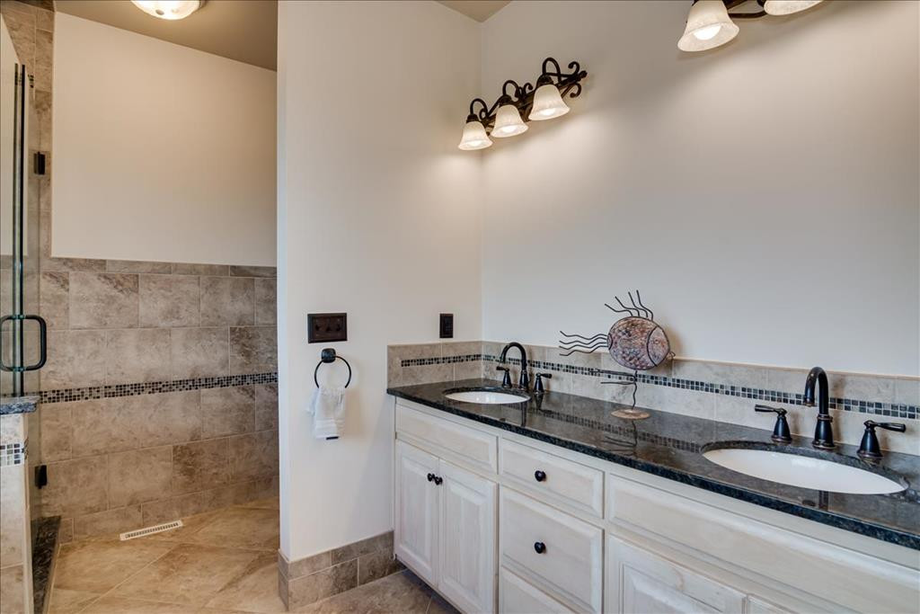 237 Implement Road Aiken, SC 29803 - Photo 18 of 43 a bathroom with a granite countertop sink a mirror and shower
